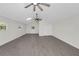 Bright, open living room with hardwood floors, a skylight, and multiple ceiling fans at 9332 Windy Ridge Rd, Windermere, FL 34786