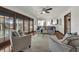 Cozy living room featuring a ceiling fan, white rug, and wood framed glass doors to the outside at 9332 Windy Ridge Rd, Windermere, FL 34786