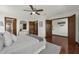 Well-lit main bedroom featuring hardwood floors, multiple closets, and a convenient ceiling fan at 9332 Windy Ridge Rd, Windermere, FL 34786