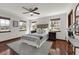 Bright main bedroom with hardwood floors, a ceiling fan, and windows with natural light at 9332 Windy Ridge Rd, Windermere, FL 34786