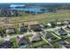 Aerial view of a residential neighborhood by a lake and open space at 9716 Royal Vista Ave, Clermont, FL 34711