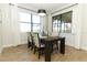 Dining room features wood flooring, lots of natural light and seating for four at 9716 Royal Vista Ave, Clermont, FL 34711