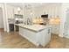 Kitchen featuring stainless steel appliances, light countertops, and wood flooring at 9716 Royal Vista Ave, Clermont, FL 34711