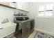 Bright laundry room with sink, washer, dryer, and white cabinets at 9716 Royal Vista Ave, Clermont, FL 34711