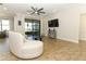 Bright living room with tile floors and view to covered patio at 9716 Royal Vista Ave, Clermont, FL 34711