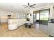 Open-concept living area with tile floors, leading to the kitchen and patio at 9716 Royal Vista Ave, Clermont, FL 34711