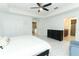 Bright and airy main bedroom features marble floors, ceiling fan and ensuite bathroom at 9716 Royal Vista Ave, Clermont, FL 34711