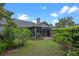 Charming backyard with lush foliage, a screened-in porch, and a well-manicured lawn at 978 Cobbler Ct, Longwood, FL 32750