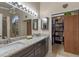 Bathroom showcasing double sinks, granite countertops, and an access to a walk-in closet at 978 Cobbler Ct, Longwood, FL 32750