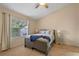 Bedroom with plush carpet, ceiling fan and window letting in natural light at 978 Cobbler Ct, Longwood, FL 32750