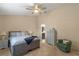 Bedroom with a ceiling fan, carpet, and a dresser with decor, leading to the bathroom at 978 Cobbler Ct, Longwood, FL 32750