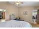 Bedroom featuring a ceiling fan, soft carpet, and a view into the closet and another room at 978 Cobbler Ct, Longwood, FL 32750