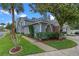 Home exterior with blue siding, a lush lawn, mature trees, and well-maintained landscaping at 978 Cobbler Ct, Longwood, FL 32750