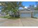 Two car garage featuring a modern door design and well-maintained landscaping in a quaint neighborhood at 978 Cobbler Ct, Longwood, FL 32750