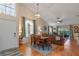 Inviting living room with vaulted ceilings, a dining room set, and a cozy atmosphere with abundant natural light at 978 Cobbler Ct, Longwood, FL 32750