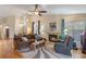 Inviting living room with a cozy fireplace, ceiling fan, and comfortable seating area at 978 Cobbler Ct, Longwood, FL 32750