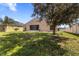 Lush backyard with mature trees and a screened lanai area at 1018 Highland Meadows St, Davenport, FL 33837