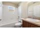 This bathroom has a single sink vanity and a tiled tub and shower combo at 1018 Highland Meadows St, Davenport, FL 33837