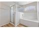 Clean bathroom featuring a separate shower and a garden tub under an arched window for a spa-like experience at 1018 Highland Meadows St, Davenport, FL 33837