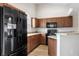 Well-equipped kitchen features modern appliances, wooden cabinets, and ample counter space at 1018 Highland Meadows St, Davenport, FL 33837