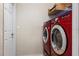 This laundry room features a stacked washer and dryer and a storage shelf at 1018 Highland Meadows St, Davenport, FL 33837