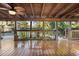 This wooden deck with a view of the pool features tropical landscaping at 1149 Doyle Rd, Deltona, FL 32725