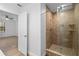 Bathroom with a glass-enclosed shower and a door leading to the bedroom at 1149 Doyle Rd, Deltona, FL 32725