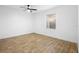 This is an empty bedroom with wood floors, a ceiling fan, and a window at 1149 Doyle Rd, Deltona, FL 32725