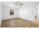 Bedroom with wood-look tile flooring, a ceiling fan, and large window at 1149 Doyle Rd, Deltona, FL 32725