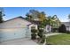 Charming one-story home featuring well-manicured landscaping and an attached two-car garage at 1149 Doyle Rd, Deltona, FL 32725