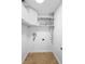 This laundry room has tile floors and multiple shelves at 1149 Doyle Rd, Deltona, FL 32725