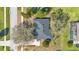 Aerial view of the home with its large backyard, mature trees and private driveway at 11706 Regal Ridge Ln, Clermont, FL 34711
