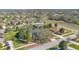 Wide aerial view of the home in a quiet neighborhood with lush lawns and mature trees at 11706 Regal Ridge Ln, Clermont, FL 34711