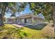Large backyard with a covered patio and fire pit, great for outdoor living and relaxation at 11706 Regal Ridge Ln, Clermont, FL 34711