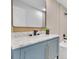 Stylish bathroom featuring blue vanity with marble countertop and gold hardware at 11706 Regal Ridge Ln, Clermont, FL 34711