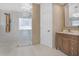 Modern bathroom featuring walk in shower, vanity and custom mirror at 11706 Regal Ridge Ln, Clermont, FL 34711