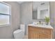 Bathroom featuring marble-look tile and wood vanity with gold hardware at 11706 Regal Ridge Ln, Clermont, FL 34711