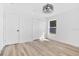 Bright bedroom features modern light fixture, closet, and window at 11706 Regal Ridge Ln, Clermont, FL 34711