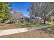 Inviting single-story home featuring a lush green lawn, mature landscaping, and a welcoming walkway at 11706 Regal Ridge Ln, Clermont, FL 34711