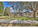 Charming single-story home with a well-maintained lawn and mature trees enhancing its curb appeal at 11706 Regal Ridge Ln, Clermont, FL 34711
