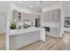Modern kitchen featuring a large island, sleek cabinets, stainless steel appliances, and stylish backsplash at 11706 Regal Ridge Ln, Clermont, FL 34711
