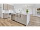 Modern kitchen island with a stainless steel sink, ample storage, and views of the open-concept living area at 11706 Regal Ridge Ln, Clermont, FL 34711