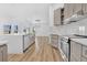 Modern kitchen featuring an island, stainless steel appliances, and open access to the living room at 11706 Regal Ridge Ln, Clermont, FL 34711