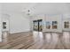 Bright living room with wood flooring and a modern chandelier at 11706 Regal Ridge Ln, Clermont, FL 34711