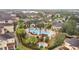 Aerial view of community pool and lush tropical landscaping and residential buildings at 12008 Villanova Dr # 112, Orlando, FL 32837