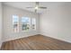 Bright and airy bedroom featuring modern wood floors and multiple windows at 12008 Villanova Dr # 112, Orlando, FL 32837