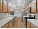 Bright kitchen featuring stainless steel appliances, light wood cabinets, and light countertops at 12008 Villanova Dr # 112, Orlando, FL 32837
