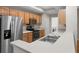 Bright kitchen featuring stainless steel appliances, light wood cabinets, and light countertops at 12008 Villanova Dr # 112, Orlando, FL 32837
