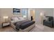 Cozy bedroom with a large bed, stylish decor, and a view of the bathroom with a walk-in shower at 1210 Alstonia Ln, Mount Dora, FL 32757