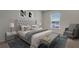 Comfortable bedroom features a plush bed with tufted headboard, soft linens, and abundant natural light at 1210 Alstonia Ln, Mount Dora, FL 32757